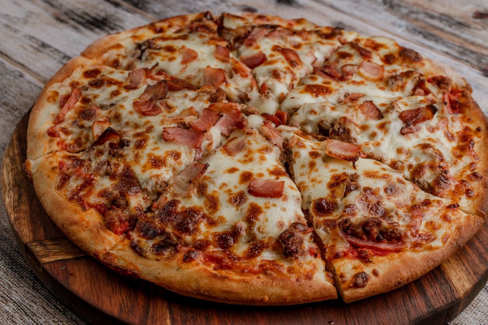 Meat Gourmet pizza with bacon and seasoned beef at Presto Pizzeria Rosedale