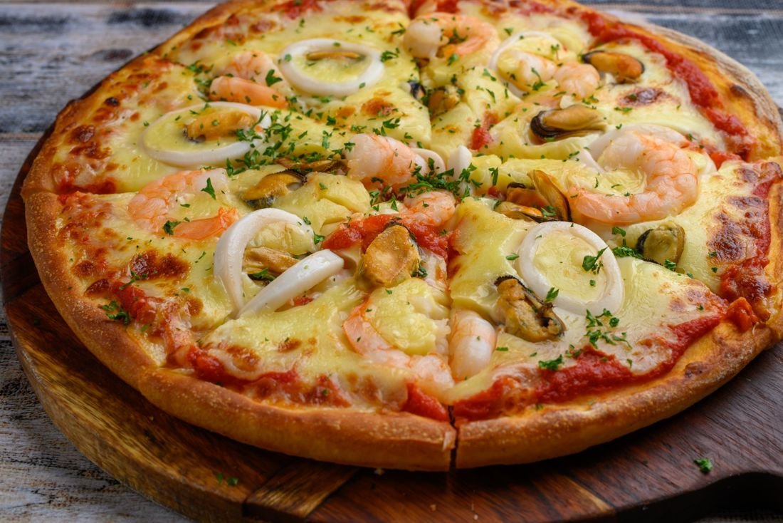 Seafood pizza with prawns, squid and mussels