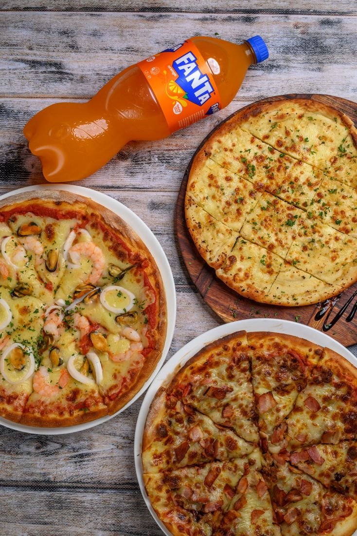 Seafood pizza, garlic bread and Meat Gourmet pizza